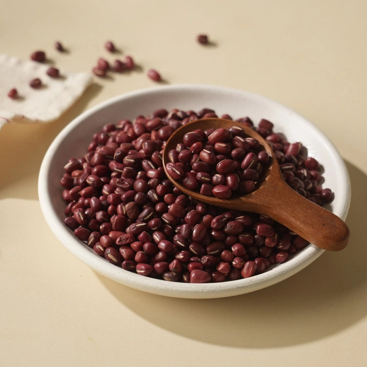 Bowl of pesticide-free Korean red beans with wooden spoon