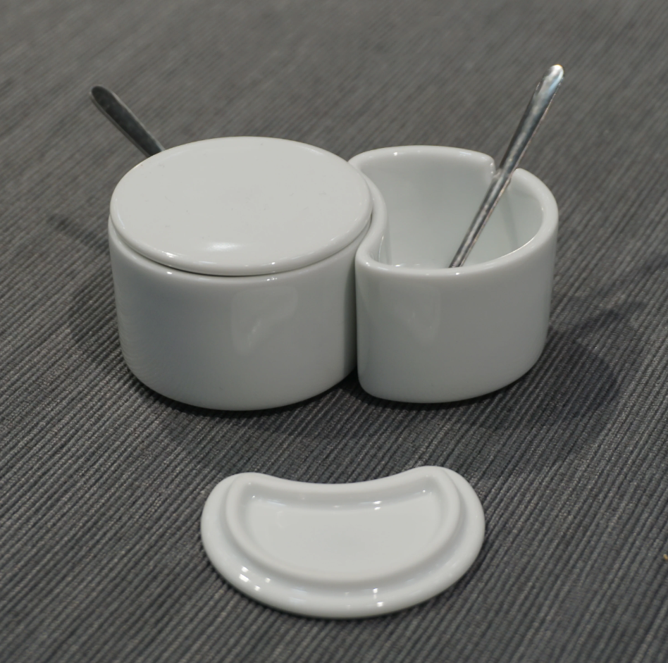 White spice container set with two canisters, spoons, and a spare curved lid