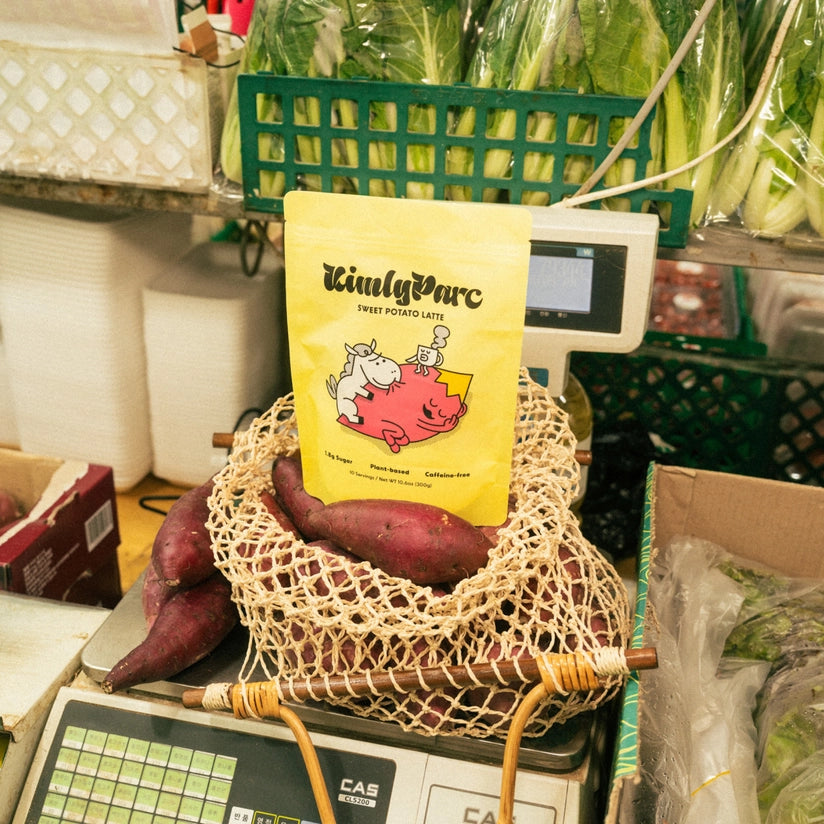 Sweet potato latte powder pouch in a produce basket, TaimlyParc logo on yellow pack