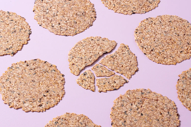 Round crispy black rice taro chips in a scattered pattern