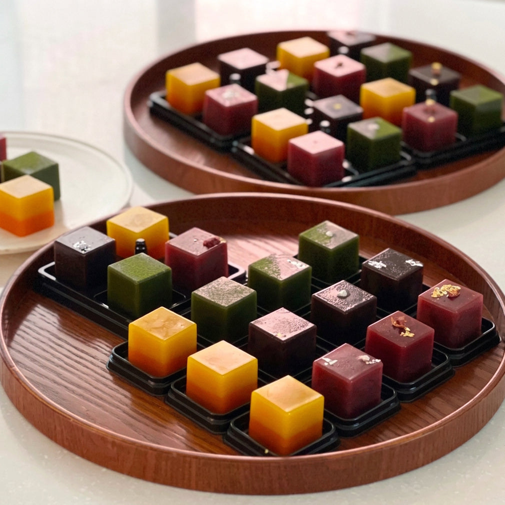 Cube yanggaeng assortments in round wooden tray, colorful red, yellow, green, dark cubes
