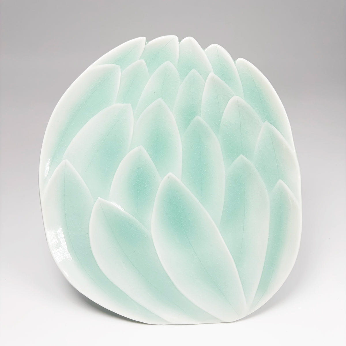 Sky blue lotus dessert plate with embossed petal swirl and smooth rim
