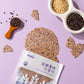 Black rice taro chips scattered around an open bag and bowls of grains