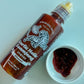 Garlic Holic Ssamjang sauce bottle (Original) with a small cup of dark sauce
