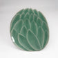 Celadon green lotus dessert plate with raised leaf-petal texture on a shallow bowl
