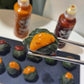 Ssamjang sauce bite on lettuce leaf, with orange paste and meat filling