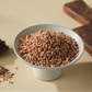 Bowl filled with red millet grains