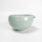 Jade green ceramic matcha bowl with wide rim and handle-like spout
