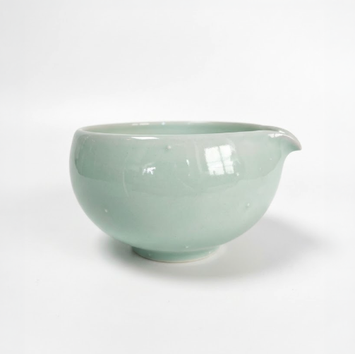 Jade green ceramic matcha bowl with wide rim and handle-like spout