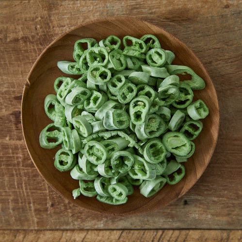 Wooden bowl of sliced green Cheongyang chili peppers