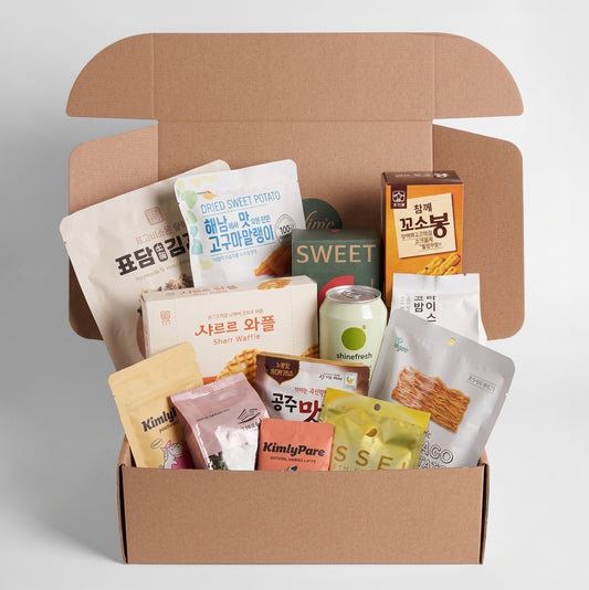Open snack box showing multiple packaged snacks, including sweet potato and wafer snacks