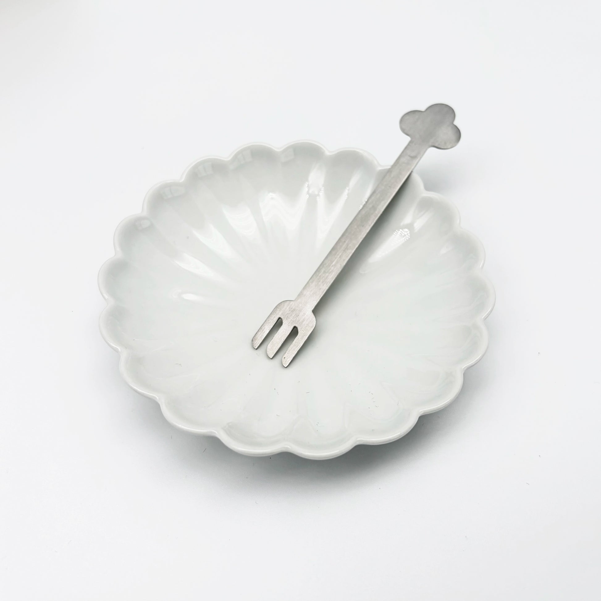 Flower-shaped dessert plate with matching fork, white ceramic