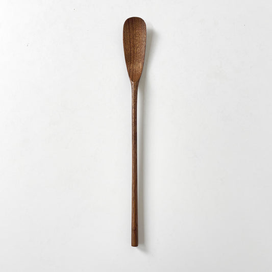 Dark wood jam spoon with an oval bowl and long handle, standing upright