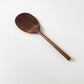 Dark wood rice paddle with textured oval scoop and long handle