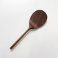 Dark wood rice paddle with textured oval scoop and long handle, angled