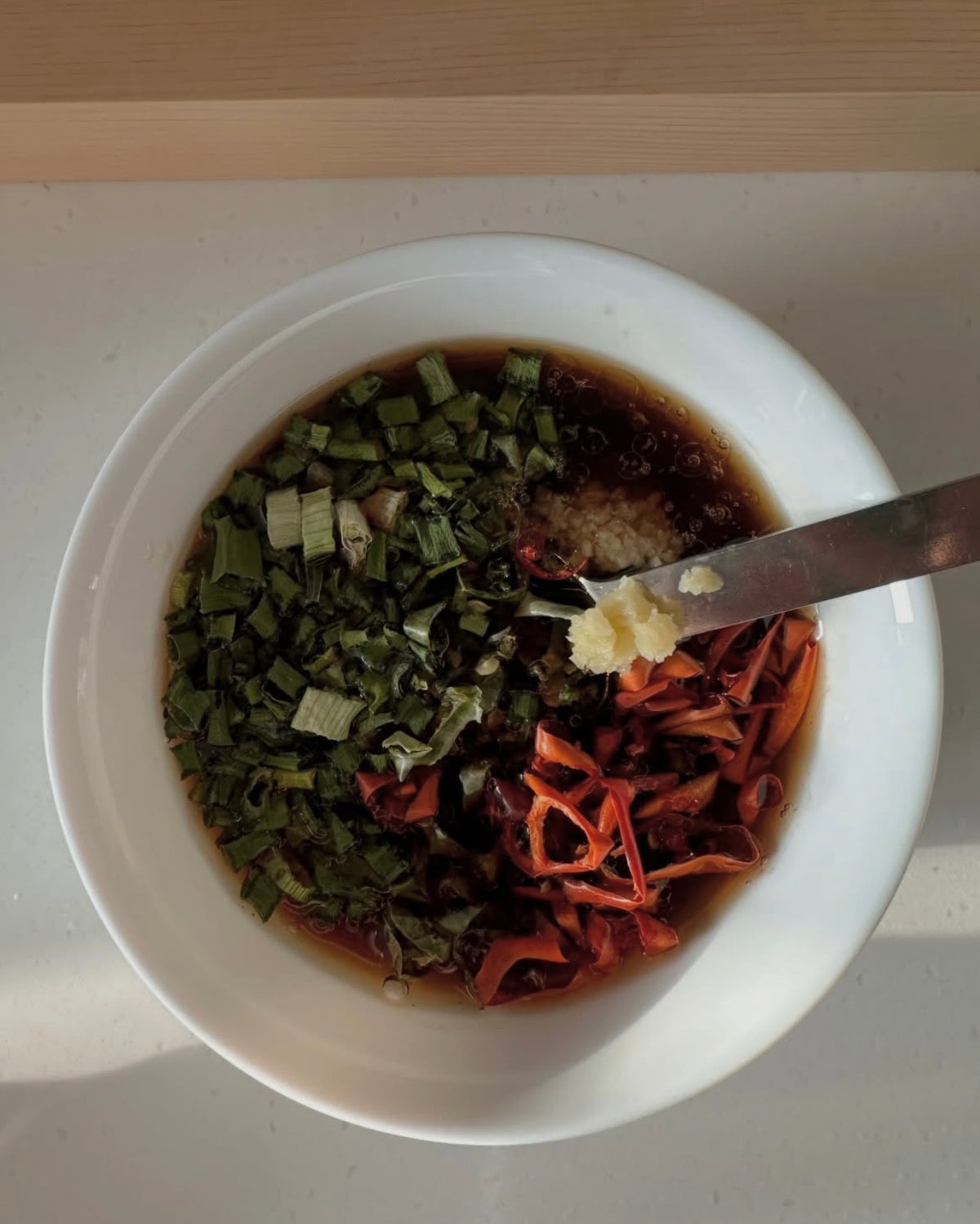 Bowl of chopped dried peppers and herbs with a knife
