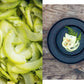 Chopped green vegetables on wood with a dark bowl containing sliced kimchi