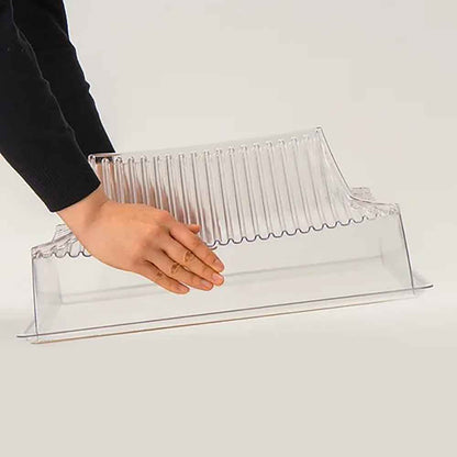 Clear slatted tabletop cover placed on transparent acrylic base