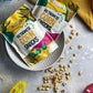 Crispy corn snack bags and plate with scattered golden kernels