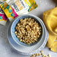 Crispy corn snack in a blue ceramic bowl filled with golden popped kernels