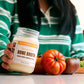 Pasture-raised chicken bone broth jar with tomatoes on countertop