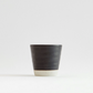 Dark ceramic water cup with light speckled base