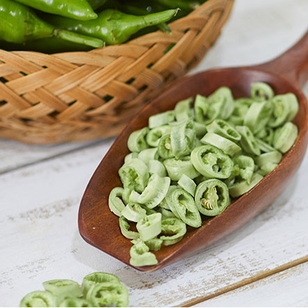 Wooden spoon filled with sliced green Cheongyang chili peppers