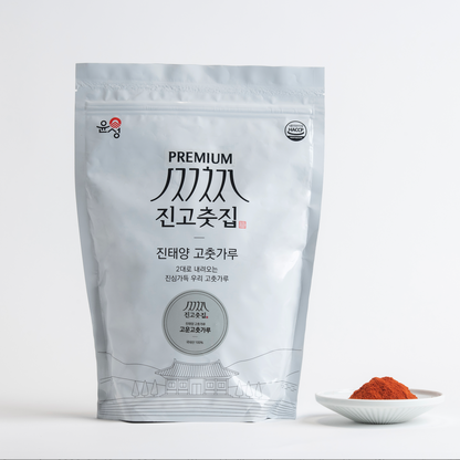 Coarse gochugaru stand-up pouch with a small bowl of red chili powder
