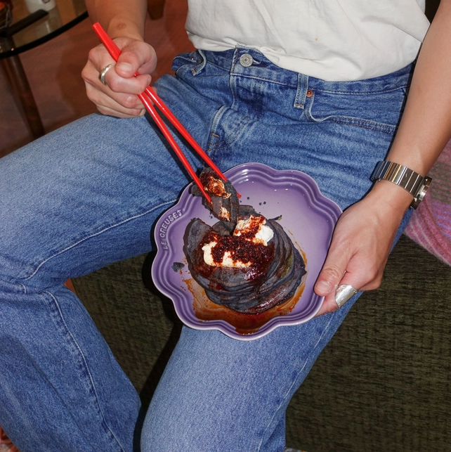 Ube mochi pancakes on a plate with chopsticks and spoon