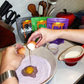 Ube mochi pancake batter with egg in a mixing bowl and red pourer