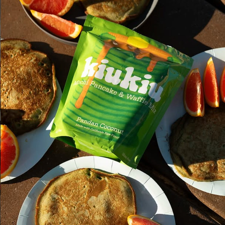 Pandan mochi pancake and waffle mix pouch among pancakes on plates
