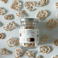 Dried lotus root jar with silver lid surrounded by sliced dried lotus pieces