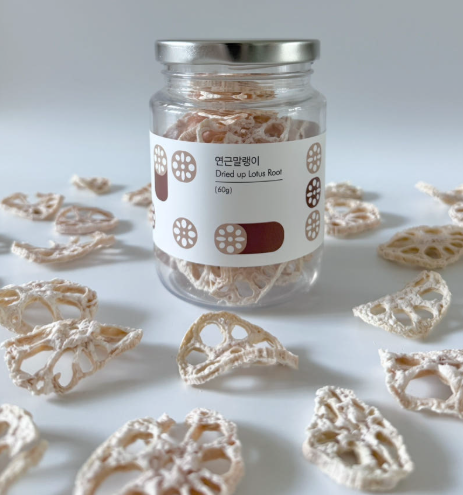 Dried lotus root jar with silver lid and label, with dried slices around