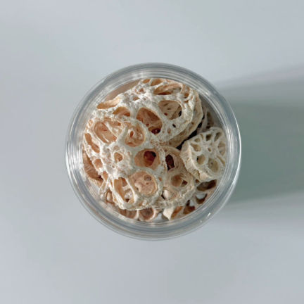 Glass jar of dried lotus root slices, top view