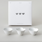 Flower tiny bowl set: three white flower-shaped bowls displayed on a tabletop.