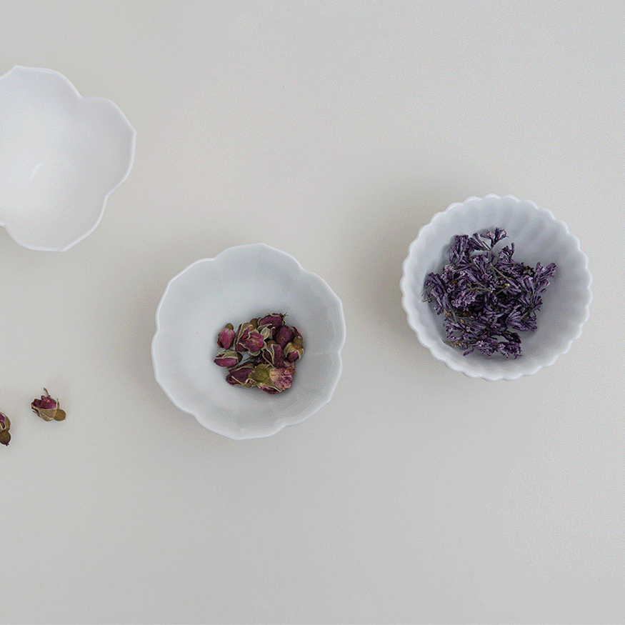 Flower tiny bowl set: three white flower-shaped bowls, one filled with purple dried herbs.