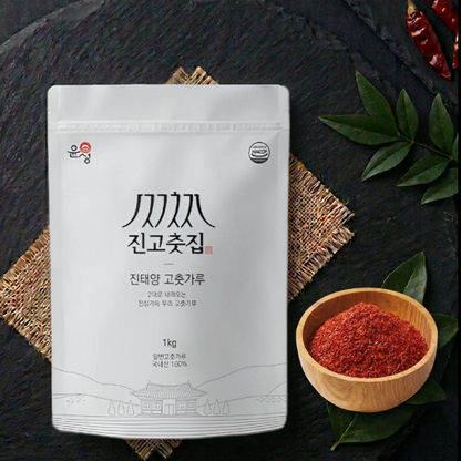 Bag of coarse Korean gochugaru chili powder with wooden bowl of red flakes