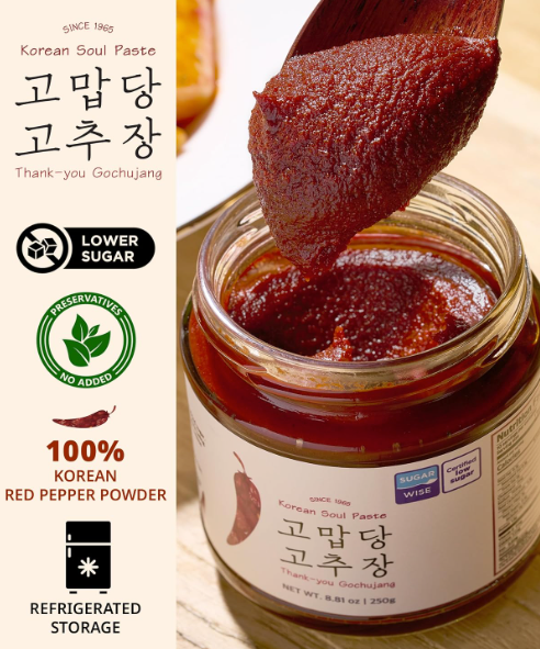 Thank-You gochujang paste in glass jar with thick red chili paste on spoon