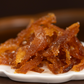 Close-up of orange candied yuja jelly strips on white dish