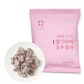A pink package of Korean candy-coated almonds with a small white plate showing several coated almonds in front, on a clean white background.