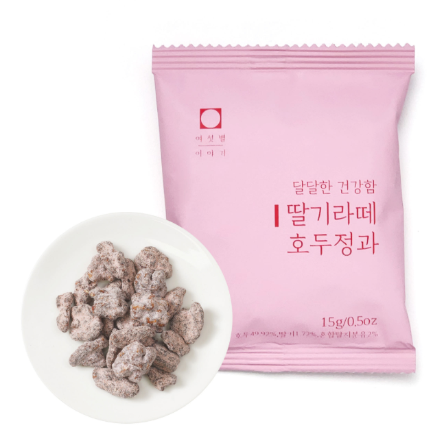 A pink package of Korean candy-coated almonds with a small white plate showing several coated almonds in front, on a clean white background.