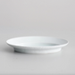 White oval serving plate close-up, shallow bowl with glossy interior