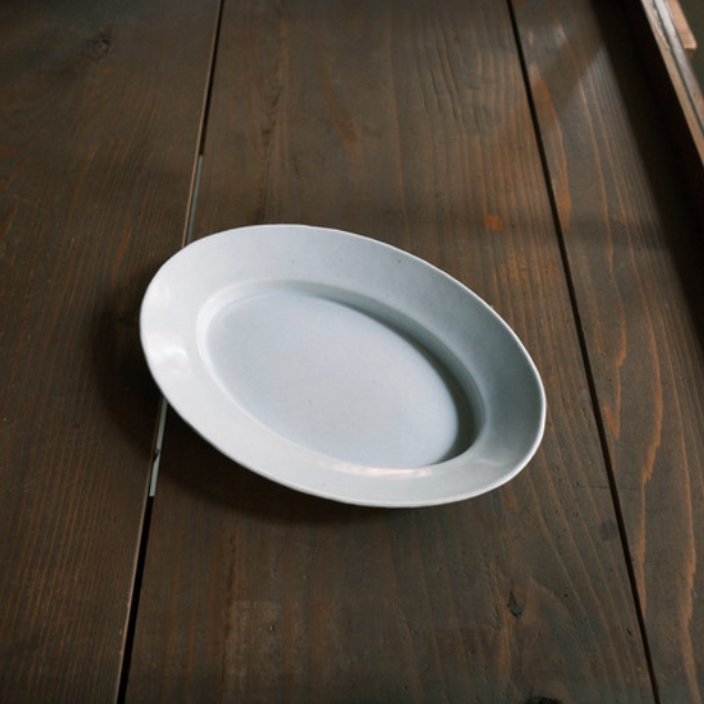 White oval serving plate, shallow dish shape with glossy surface