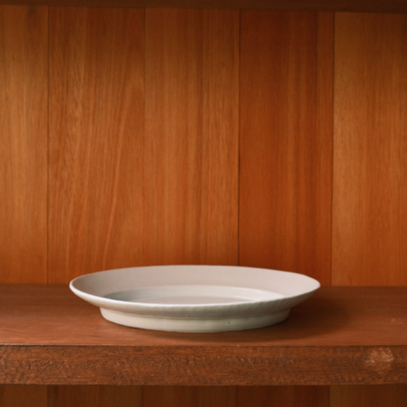 White oval serving plate, shallow bowl form with low curved sides