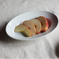 White oval plate holding sliced figs