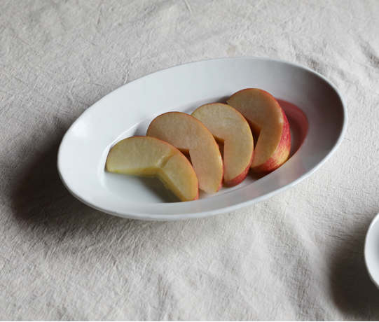 White oval plate holding sliced figs