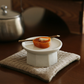Octagonal petite ceramic soban in light cream, holding an orange snack in the bowl