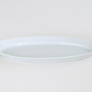 White oval serving plate with wide rim and shallow tray