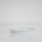 White oval plate, empty, low side view