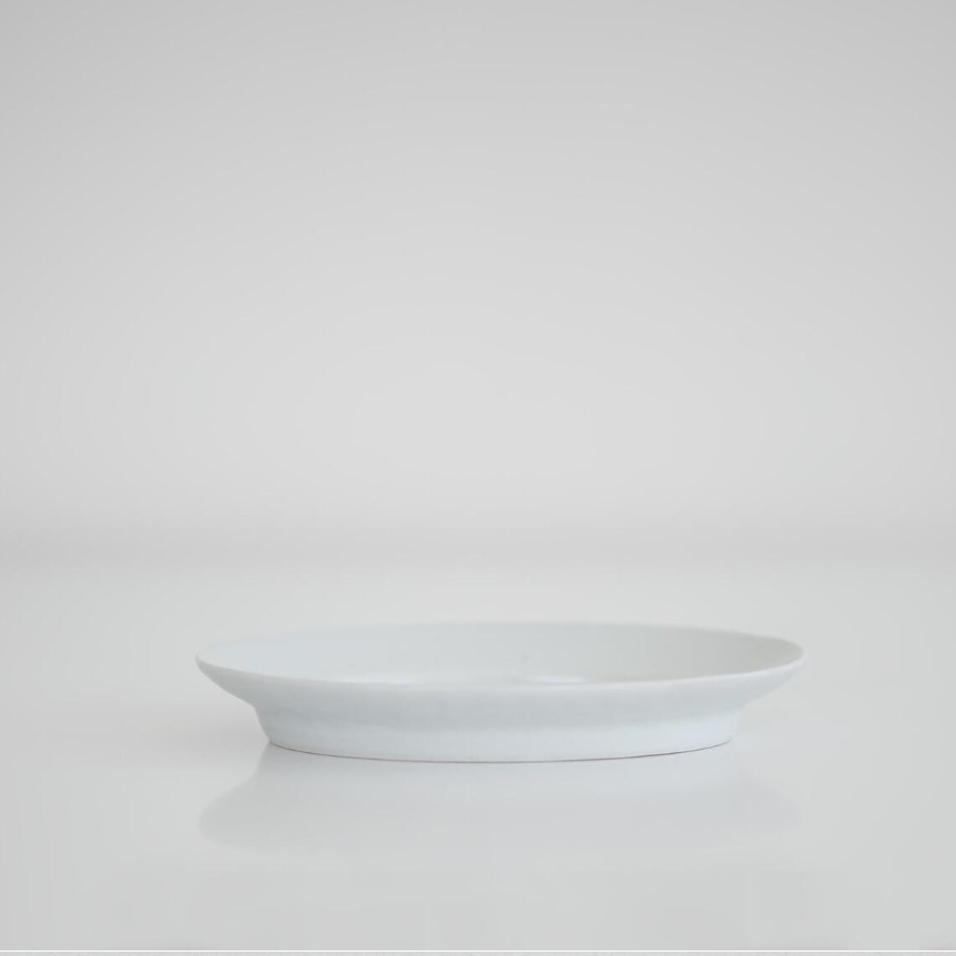 White oval plate, empty, low side view